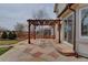 Back patio featuring a stone surface, wood pergola and view of backyard at 18292 E Caspian Pl, Aurora, CO 80013
