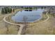 Scenic view of a community pond and walking path, perfect for enjoying nature at 18292 E Caspian Pl, Aurora, CO 80013