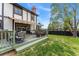 Inviting deck with outdoor seating, a patterned rug, and a lush green lawn at 7706 S Crocker Ct, Littleton, CO 80120