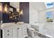 Bathroom with marble floors, a free-standing tub, dual vanities, and modern lighting fixtures at 7706 S Crocker Ct, Littleton, CO 80120