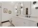 Modern bathroom featuring double sinks with marble countertop, sleek black fixtures, and decorative tile flooring at 7706 S Crocker Ct, Littleton, CO 80120