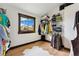 An organized walk-in closet featuring wooden floors, metal racks, and a window with a view at 7706 S Crocker Ct, Littleton, CO 80120