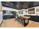 Elegant dining room with a modern chandelier, wood ceiling, and a view of the kitchen at 7706 S Crocker Ct, Littleton, CO 80120