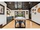 Spacious dining room with a modern light fixture, wood ceiling, and a view of the exterior at 7706 S Crocker Ct, Littleton, CO 80120