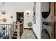 Hallway with oak floors, a stairwell, and stacked washer/dryer in an elegant and modern design at 7706 S Crocker Ct, Littleton, CO 80120