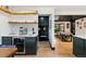 Convenient kitchenette with modern appliances, custom cabinets, and a wine fridge at 7706 S Crocker Ct, Littleton, CO 80120