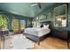 Luxurious bedroom featuring wood flooring, ceiling fan, many mirrors and a view out a large window at 7706 S Crocker Ct, Littleton, CO 80120