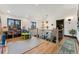 Second-floor playroom featuring a large window and hardwood flooring with black railing stairs at 7706 S Crocker Ct, Littleton, CO 80120