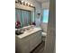 Bright bathroom features a vanity with storage and a large mirror at 1233 Lansing St, Aurora, CO 80010