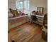 Bedroom with hardwood floors, a bright window, and a built-in bed frame and desk at 1233 Lansing St, Aurora, CO 80010