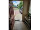 Open entryway showing the driveway and lush green trees outside at 1233 Lansing St, Aurora, CO 80010
