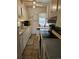 Compact kitchen featuring white appliances and cabinets and plenty of counter space at 1233 Lansing St, Aurora, CO 80010