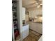 Kitchen with white cabinets and pantry space, offering ample storage and functionality at 1233 Lansing St, Aurora, CO 80010