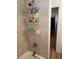 Shower boasts tile surround with convenient shelving and modern fixtures at 1233 Lansing St, Aurora, CO 80010