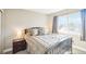 Comfortable bedroom featuring a large bed, side table, and natural light from the window at 17158 Cornerstone Dr, Parker, CO 80134