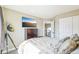 Well-lit bedroom with TV, dresser, open doorway and neutral decor at 17158 Cornerstone Dr, Parker, CO 80134