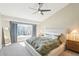 Bright bedroom featuring a large window, ceiling fan and modern decor at 17158 Cornerstone Dr, Parker, CO 80134