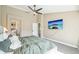 Bright bedroom features a ceiling fan, TV, and access to the ensuite bathroom at 17158 Cornerstone Dr, Parker, CO 80134