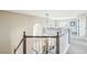 Hallway with staircase and decorative lighting, leading to a comfortable living area at 17158 Cornerstone Dr, Parker, CO 80134