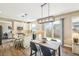 Bright kitchen and dining area with white cabinets, an island and sliding glass doors to backyard at 17158 Cornerstone Dr, Parker, CO 80134