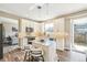 Well-lit kitchen featuring a center island, stainless appliances and sliding doors to the outdoor area at 17158 Cornerstone Dr, Parker, CO 80134