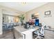 Bright office space featuring a modern desk, computer setup, and view to the dining room at 17158 Cornerstone Dr, Parker, CO 80134