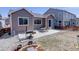 Spacious backyard with patio, BBQ grill, fire pit, and rock landscaping, ideal for outdoor living at 17718 Leisure Lake Dr, Monument, CO 80132