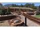 Beautiful backyard featuring landscaped garden beds, wood fencing, a built-in grill, and mountain views at 17718 Leisure Lake Dr, Monument, CO 80132