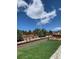 Landscaped backyard with retaining wall, tiered garden beds, lawn, and modern fence at 17718 Leisure Lake Dr, Monument, CO 80132
