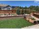 Beautiful backyard with manicured lawn, mature trees and garden beds at 17718 Leisure Lake Dr, Monument, CO 80132