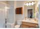 Bathroom with a glass-enclosed shower, vanity, mirror, and a cabinet, offering both style and functionality at 17718 Leisure Lake Dr, Monument, CO 80132