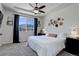 Bedroom with modern ceiling fan, scenic backyard view, neutral color palette, and carpet flooring at 17718 Leisure Lake Dr, Monument, CO 80132