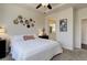 Relaxing bedroom with king bed, tray ceiling, unique wall decor, and attached bathroom at 17718 Leisure Lake Dr, Monument, CO 80132