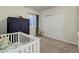 Bright bedroom featuring a baby crib, dresser, and ample closet space, offering both comfort and functionality at 17718 Leisure Lake Dr, Monument, CO 80132
