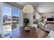 Bright dining area with large windows overlooking the backyard and a round table perfect for gatherings at 17718 Leisure Lake Dr, Monument, CO 80132