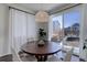 Dining room with a large window, white curtains, backyard view, and a round dining table with seating for six at 17718 Leisure Lake Dr, Monument, CO 80132