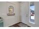 Bright entryway with a stylish mirror, coat rack, and a view of the neighborhood at 17718 Leisure Lake Dr, Monument, CO 80132