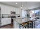 Modern kitchen with white cabinets, granite countertops, stainless steel appliances, and an adjacent dining area at 17718 Leisure Lake Dr, Monument, CO 80132