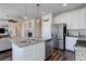 Modern kitchen and open living area with granite island, stainless steel appliances, and view to living room fireplace at 17718 Leisure Lake Dr, Monument, CO 80132