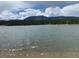 Scenic lake view with ripples in the water and mountains in the distance at 17718 Leisure Lake Dr, Monument, CO 80132
