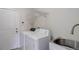 Laundry room with a washer, dryer, utility sink, and door at 17718 Leisure Lake Dr, Monument, CO 80132