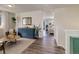 Open-concept living room with stylish furniture, wood floors, and ample space for entertaining at 17718 Leisure Lake Dr, Monument, CO 80132