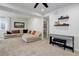 Cozy living room area with carpeted floors, shelves, and a comfortable couch, perfect for relaxing or entertaining at 17718 Leisure Lake Dr, Monument, CO 80132