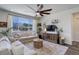 Bright and airy living room featuring a large window, comfortable seating, and mountain views at 17718 Leisure Lake Dr, Monument, CO 80132