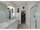 Bright bathroom with double sinks, granite counters, walk-in shower and walk-in closet at 17718 Leisure Lake Dr, Monument, CO 80132