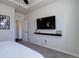 Bright bedroom features a large wall-mounted TV and a decorative shelf at 17718 Leisure Lake Dr, Monument, CO 80132