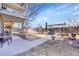 Large backyard with a concrete patio area, perfect for outdoor dining and entertaining guests at 5011 Troy St, Denver, CO 80239