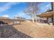 Spacious backyard featuring a covered patio and a charming swing for relaxing outdoors at 5011 Troy St, Denver, CO 80239