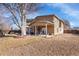 Spacious backyard with a covered patio and ample room for outdoor activities and relaxation at 5011 Troy St, Denver, CO 80239