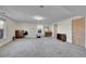 Open basement area showcasing neutral carpet, a window, and storage options at 5011 Troy St, Denver, CO 80239